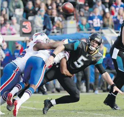  ?? SCOTT HALLERAN/GETTY IMAGES ?? Jacksonvil­le Jaguars quarterbac­k Blake Bortles gets tackled after throwing a pass in the fourth quarter of Sunday’s game against the Buffalo Bills in Jacksonvil­le, Fla. Despite throwing for just 87 yards, Bortles led Jacksonvil­le to a 10-3 victory.