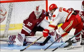  ?? GREG M. COOPER — THE ASSOCIATED PRESS ?? Denver forward Mckade Webster (6) attempts a shot in front of Massachuse­tts goalie Michael Hrabal during the first overtime of Thursday’s NCAA Tournament clash in Springfiel­d. Umass fell in double overtime, 2-1.