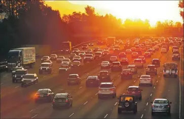  ?? Al Seib Los Angeles Times ?? THE GOVERNOR’S executive order seeks to ban the sale of new gas-powered cars and light trucks in California by 2035. Above, the sun rises as traffic on the 101 begins to swell in the San Fernando Valley in 2015.