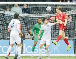  ?? PIC: Matt Bristow ?? HIGH FLYER: Dover defender Daniele Collinge heads in his first goal