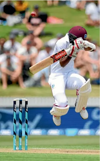  ?? PHOTO: PHOTOSPORT ?? West Indies opener Kraigg Braithwait­e takes evasive action to a bouncer from Trent Boult.