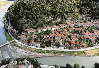  ?? Mary Winston Nicklin / For the Washington Post ?? Berat, a magnificen­t legacy of the Ottoman Empire in central Albania, is a UNESCO World Heritage site. The city is known for its white Ottoman hillside houses above the river Osum.