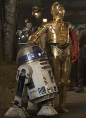  ??  ?? R2-D2, left, and C-3PO (Anthony Daniels) appear in a scene from “Star Wars: The Force Awakens.” The iconic droids have appeared in most of the “Star Wars” films.