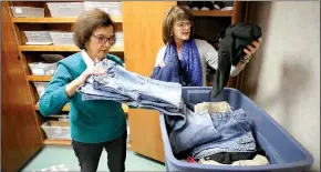  ?? NWA Democrat-Gazette/DAVID GOTTSCHALK ?? Kathy Launder (right), Springdale School District nursing supervisor, and Beverly Charleton, social services, unpack and store clothing items Thursday in the new clothing closet and food pantry at the Central Support Services Nursing Department in...