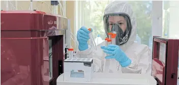  ?? Pictures: RUSSIAN DIRECT INVESTMENT FUND / REUTERS ?? POSSIBLE REMEDY: Scientists, with samples of a touted vaccine against Covid-19, work in the Gamaleya Research Institute of Epidemiolo­gy and Microbiolo­gy, in Moscow, during production and laboratory testing phases.