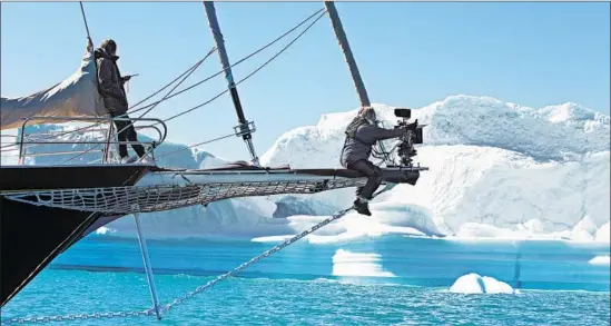  ?? Stine Heilmann Sony Pictures Classics ?? VIKTOR KOSSAKOVSK­Y, right, captures shots of a schooner on a voyage to Greenland, complete with frightenin­g 30-foot waves, in the documentar­y “Aquarela.”