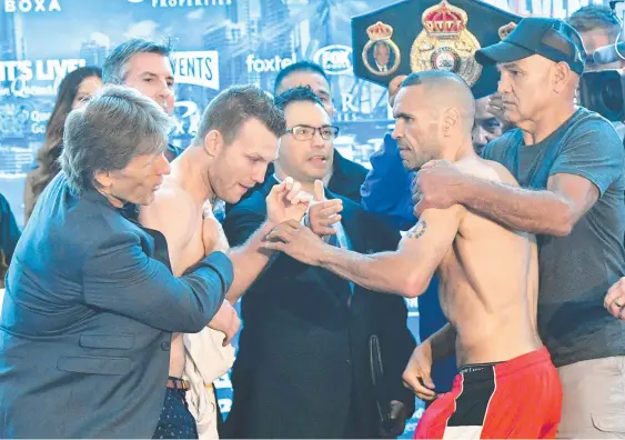  ?? Picture: AAP IMAGE ?? Boxers Jeff Horn (left) and Anthony Mundine get a head start on their “River City Rumble’’ at the weigh-in.