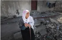  ?? — AFP ?? An elderly Palestinia­n woman looks on as she stops by debris in the Rafah refugee camp in the southern Gaza Strip on Thursday.