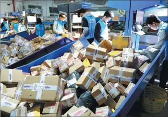  ?? ZHANG KAIHU / FOR CHINA DAILY ?? Workers at a distributi­on center in Lianyungan­g, Jiangsu province, sort parcels on Wednesday.