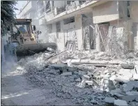  ?? AP PHOTO ?? This photo provided by the Syrian Civil Defense White Helmets, which has been authentica­ted based on its contents and other AP reporting, shows citizens clearing debris in a street a day after airstrikes hit, in the Damascus suburb of Arbeen, Syria on...