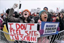  ?? NAM Y. HUH THE ASSOCIATED PRESS ?? Demonstrat­ors hold signs during a March for Our Lives rally in Chicago on Saturday. Students and activists across the country planned events in conjunctio­n with a Washington march spearheade­d by teens from Marjory Stoneman Douglas High School in...