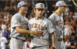  ?? CONTRIBUTE­D BY STEPHEN SPILLMAN ?? Longhorns teammates congratula­te right-hander Chase Shugart (24) after he closed out Texas’ 3-2 victory over Indiana on Sunday night.