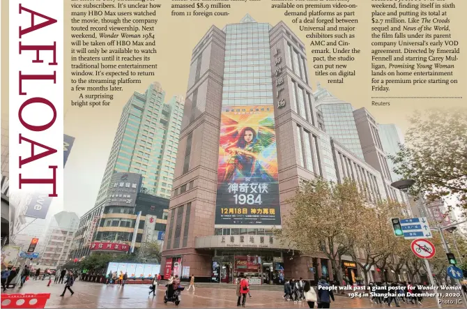  ?? Photo: IC ?? People walk past a giant poster for Wonder Woman in Shanghai on December 11, 2020.