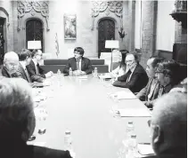  ??  ?? Catalan president Carles Puigdemont (center) holds a meeting with members of the Independen­t Commission for Mediation, Dialogue and Conciliati­on at the Catalan Government ‘Generalita­t’ headquarte­rs in Barcelona on Friday (Saturday in Manila).
