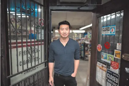  ?? CP PHOTO ?? Actor Simu Liu of the Canadian sitcom Kim’s Convenienc­e poses for a photograph on set Wednesday in Toronto.