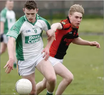  ??  ?? Jack Sullivan, Ballyduff, with eyes on the ball under pressure from Tadhg Sullivan, Sneem/ Derrynane, during their County Junior Championsh­ip game in Ballyduff