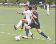  ?? Alex von Kleydorff / Hearst Connecticu­t Media ?? Staples’ Matthew Tanzer, right, goes for the ball against Danbury’s Lucas Dantas in Wednesday’s game.