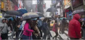  ??  ?? In this Thursday, May 25, 2017, photo, pedestrian­s make their way across 45th Street in New York’s Times Square.