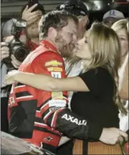 ?? DARRYL GRAHAM — THE ASSOCIATED PRESS ?? Dale Earnhardt Jr., left, hugs his wife Amy after getting out of his car at the end of a NASCAR Cup Series auto race at Homestead-Miami Speedway in Homestead, Fla., Sunday. Earnhardt is retiring from full-time racing.