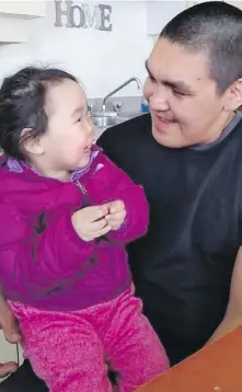  ?? MICHELLE ILLAUQM. VIA CP ?? Abraham Natanine is shown with his daughter in Clyde River, Nunavut. Natanine was shot and killed by police in May 2020 at the age of 31.