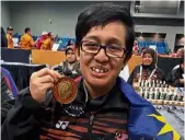  ??  ?? Gold on the chessboard: Malaysia’s Nur Feiqha Maulad posing with her gold medal on Wednesday.