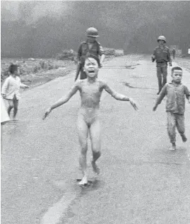  ?? NICK UT/AP ?? VIETNAM: Kim Phuc tore off her burning clothes after a South Vietnamese plane accidental­ly dropped napalm on her village in June 1972. The iconic photo won the Pulitzer Prize.