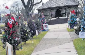  ??  ?? Trees decorated by families, organizati­ons and businesses in the Oak Forest area line the path to the city’s gazebo near 154th Street and Central Avenue. Contest winners were revealed Tuesday.