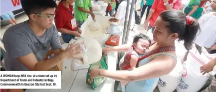  ??  ?? A WOMAN buys NFA rice at a store set up by Department of Trade and Industry in Brgy. Commonweal­th in Quezon City last Sept. 18.