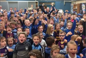  ??  ?? The silverware is held aloft as Diarmuid O’Keeffe visits his old primary school in Rathangan.