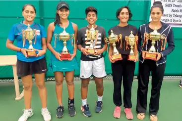  ??  ?? Winners and runners-up of the women’s events at the Telangana State Tennis Associatio­n AITA Ranking Tennis Tournament pose with their trophies at the SATS Tennis Complex in Lal Bahadur Stadium, Hyderabad on Friday.