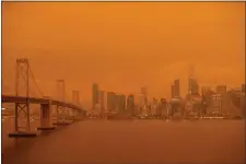  ?? RAY CHAVEZ — BAY AREA NEWS GROUP ?? Smoky skies from Northern California wildfires cast an orange and yellow color in San Francisco, Calif., on Wednesday, Sept. 9, 2020.