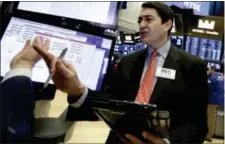  ?? RICHARD DREW — THE ASSOCIATED PRESS ?? Trader Mark Muller works on the floor of the New York Stock Exchange, Wednesday. U.S. stocks were mixed in the morning as investors waited for news on interest rates from the Federal Reserve.