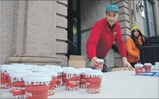  ?? LOUIS POWER/THE TELEGRAM ?? Max Staubitzer, owner of the Beavertail­s location at The Loop in Bannerman Park, gave out free hot chocolate to supporters of Choices for Youth as they took part in the Coldest Night of the Year walk.