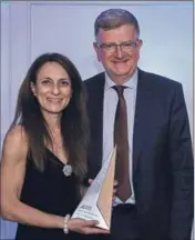  ??  ?? Fortescue People group manager Linda O’Farrell receives the Diversity and Inclusion award from Stephen Halliday, external relations and public affairs head at sponsor Heathgate Resources.