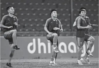  ??  ?? China national team players (from left) Wu Wei, Wu Lei and Chi Zhongguo take part in a training session in Male, Maldives, on Sunday, ahead of the 2022 World Cup qualifier against Maldives. China kicks off its qualifying campaign today. — IC