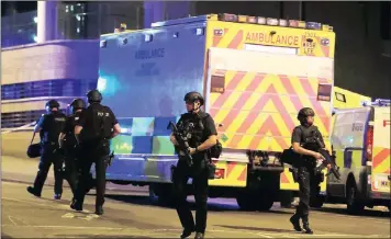  ?? PICTURES: ASSOCIATED PRESS ?? Armed police work at Manchester Arena after an explosion at the northern England venue last night. The blast occurred at the end of a concert by US singer Ariana Grande. At least 22 people were killed and more than 50 injured. A representa­tive said the...