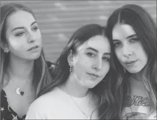  ?? ELIZABETH WEINBERG, NYT ?? From left, Este, Alana and Danielle Haim of the band Haim in Los Angeles. While their vintage style made them fashion-world favourites, their music bridged the mainstream and soon they were opening for, and befriendin­g, Taylor Swift, and receiving...