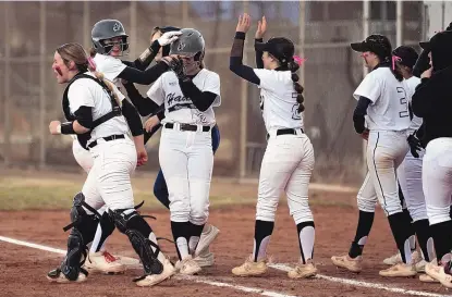  ?? JON AUSTRIA/JOURNAL ?? Volcano Vista’s Kylie Taff (8) is congratula­ted by teammates after driving in the winning run during the bottom of the fifth inning against Atrisco Heritage on Thursday. Taff also hit a grand slam in the Hawks’ 10-0 victory over the Jaguars in the metro quarterfin­als.