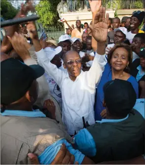  ?? ?? Above, Haiti’s former president Jean-Bertrand Aristide waves to the crowd in Port-auPrince in 2015