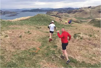 ??  ?? Runner Martin Deans (in red) from yacht Arnemetia chases the pack on top of Mull