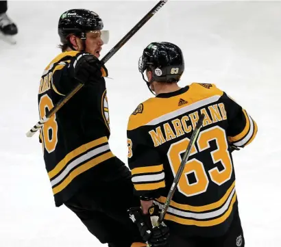  ?? STuART CAHiLL / HERALd sTAFF ?? NEED MORE: Bruins forwards Brad Marchand and David Pastrnak, left, celebrate a goal against the Devils on Tuesday night at the Garden.