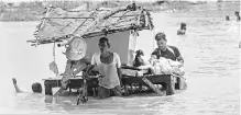  ?? PHOTO: PTI ?? People move to safer locations in Allahabad on Tuesday. Water levels in rivers have continued to rise as rains lashed parts of Uttar Pradesh