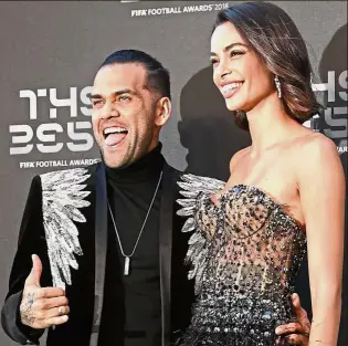  ?? — AFP ?? He loves Pep: Paris St Germain defender Dani Alves with his wife Joana Sanz at the Best FIFA Football Awards ceremony. Alves has commented that Pep Guardiola’s coaching is ‘better than sex’.