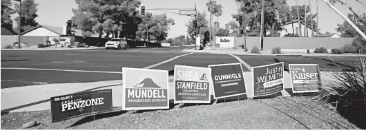  ?? DARIO LOPEZ-MILLS/AP PHOTOS ?? Electoral signs line an intersecti­on during August in Phoenix. America’s suburbs are poised to decide not just the White House but the contours of the debate over multiple issues.