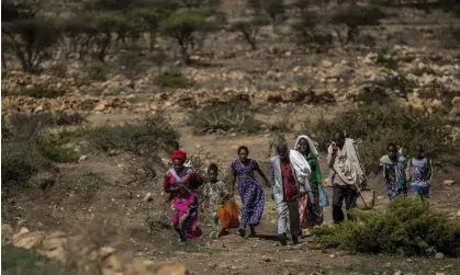  ?? Photograph: Ben Curtis/AP ?? File image of people walking to a town where a humanitari­an aid was available in the Tigray region of northern Ethiopia. Ethiopia’s government and Tigrayan rebels agreed on Saturday to facilitate immediate humanitari­an access to ‘all in need’.