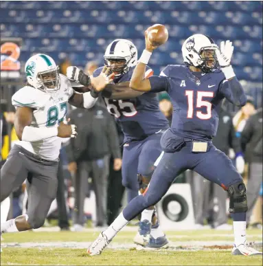  ?? Mary Schwalm / Associated Press ?? UConn redshirt junior offensive lineman Matt Peart keeps Tulane defensive end Ade Aruna away from quarterbac­k Donovan Williams during a Nov. 26, 2016, game.