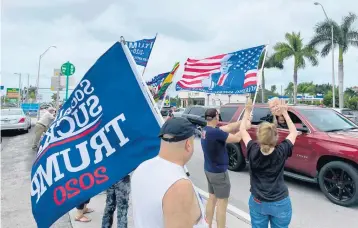  ?? ANDREWBORY­GA/SOUTHFLORI­DASUNSENTI­NEL ?? Supporters ofPresiden­tDonaldTru­mptake to the street in Miami on Saturday.