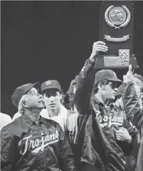  ?? AP ?? Southern California coach Rod Dedeaux, left, proudly looks at the College World Series trophy the Trojans won in Omaha, Neb., in 1974.