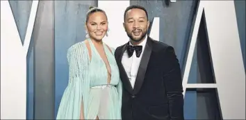  ?? Evan Agostini / AP ?? Chrissy Teigen, left, and John Legend have revealed the “deep pain” they are feeling over the loss of their unborn baby following pregnancy complicati­ons.