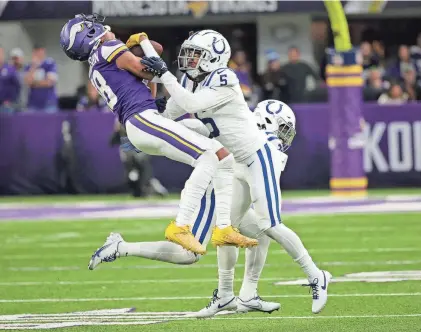  ?? ANDY CLAYTON-KING/AP ?? Vikings wide receiver Justin Jefferson (18) is tackled by Colts cornerback Stephon Gilmore (5) during the second half Saturday in Minneapoli­s.